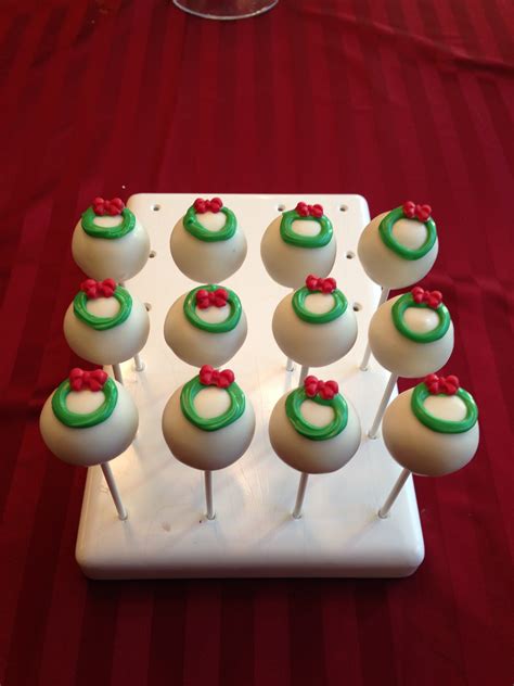 Dip the cake pops one at a time into the melted chocolate, allowing any excess chocolate to drip off and spin the pops to even out the surface. Holiday Cake Pops - Let Them Eat Pops