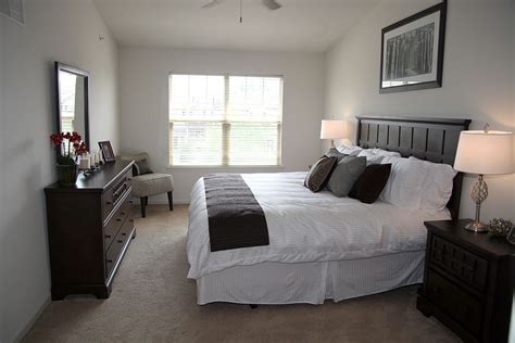 Furnished Bedroom With Carpeted Flooring And Large Windows In Heritage