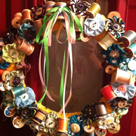 Wreath Decorated With Spools Of Thread Fabric Layers And Buttons So