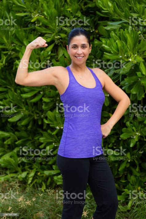 Portrait Of Fit Female Flexing Her Bicep Muscle Stock Photo Download
