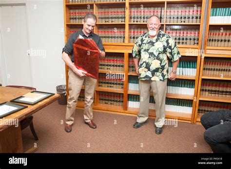 As "DJ" Thornely unwraps a gift of framed quotes from famous people