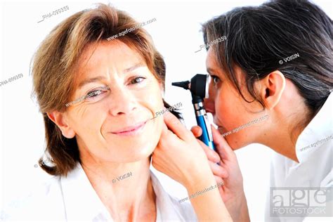 Doctor Examining The Ears Of A Patient With An Otoscope Stock Photo