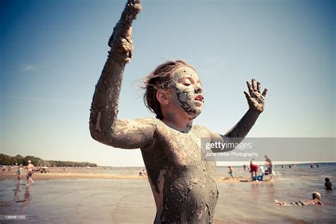 Young Girl Covered In Clay At Beach Photo Getty Images