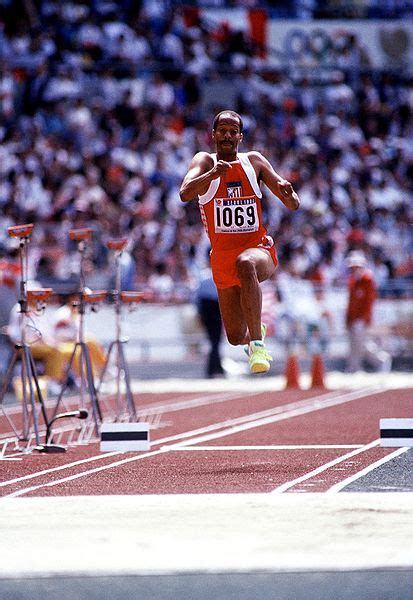 Competitors sprint along a runway before taking off from a wooden board. This Day In Olympic History: 1985 - Willie Banks broke the ...
