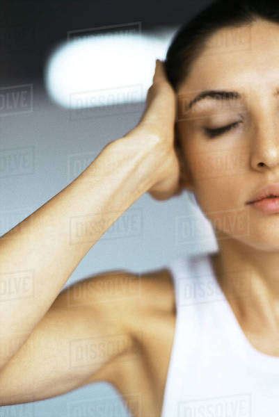 Woman With Eyes Closed Holding Head Stock Photo Dissolve