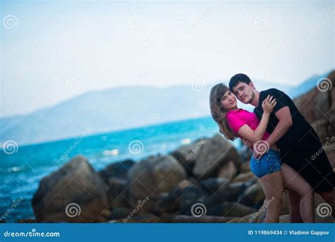 Beautiful Girl And Boy Hugging In The Background Is The Sea Stock Photo