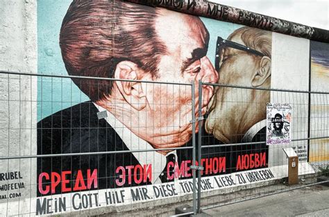 Graffiti Painting Of Kissing Brezhnev And Honecker On Berlin Wall At East Side Gallery In