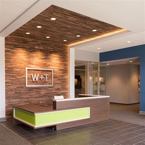 An Office Lobby With Wood And Tile Walls