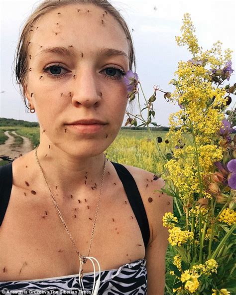 woman behind frozen eyelashes selfie shows face covered in mosquitoes hot world report