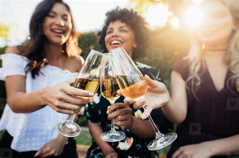 Female Friends Having Drinks At Party Outdoors Stock Photo 138603