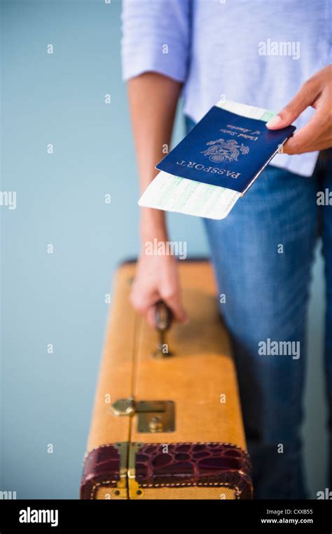 Cape Verdean Woman Holding Passport And Suitcase Stock Photo Alamy
