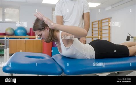 Rehabilitation Treatment Woman Lying On Her Abdomen And Doing Extension Stretch Exercises For