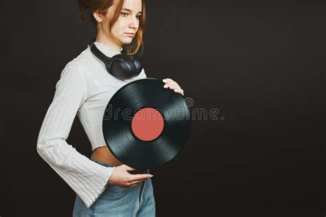 woman holding vinyl record music passion listening to music from analog record playing music