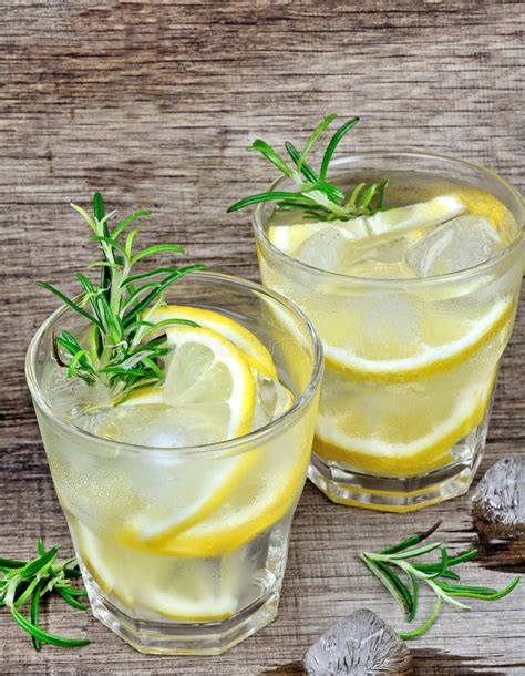 Lemon Detox Water With Rosemary In A Glasses On Wood Table Stock Photo