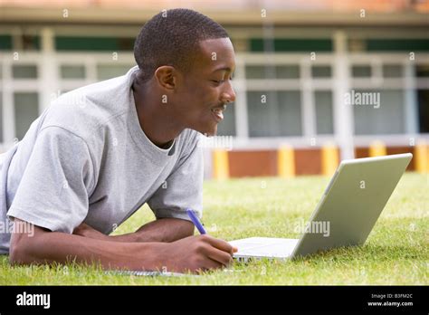 Student Lying Outdoors On Lawn With Laptop Stock Photo Alamy