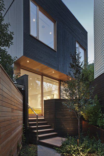An annual wash with a garden hose will keep it looking like freshly painted wood. "The black siding is contemporary, but the texture of the ...