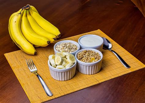 Banana Sliced Ramekin With Oatmeal Granola And Plain Yogurt As Side