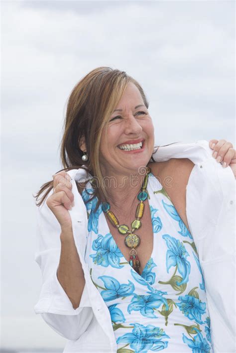 Happy Mature Woman At Beach And With Drak Clouds Stock Image Image Of