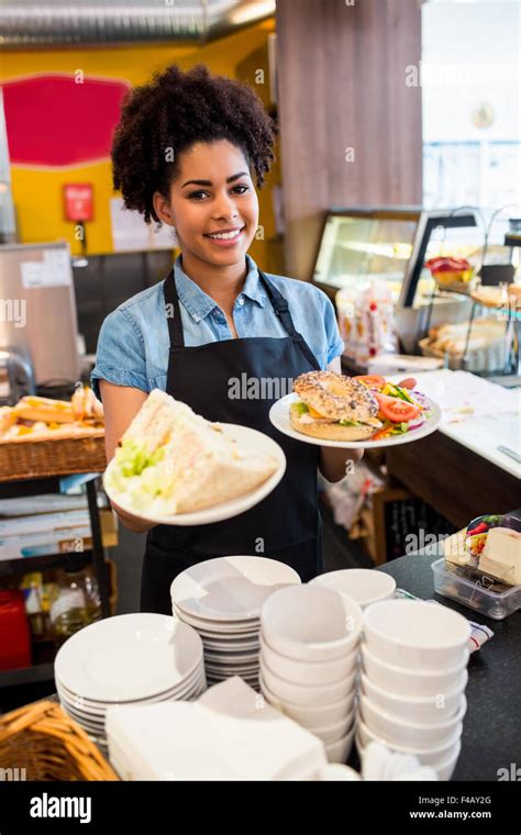 Pretty Waitress Serving Lunch To Camera Stock Photo Alamy