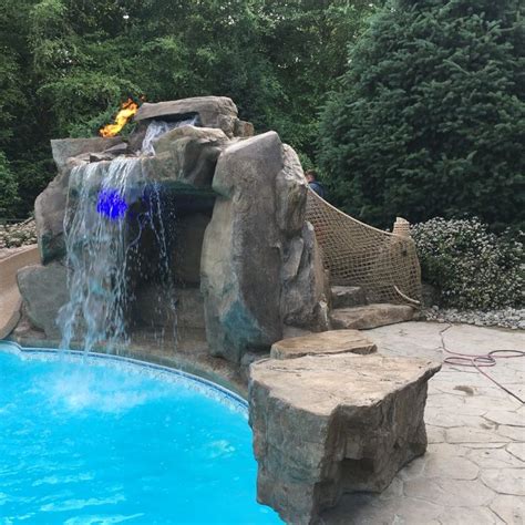 I love the rock waterfall and slide on the side of this inground pool