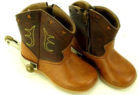 Western spurs and spur straps. Pr. of baby boy cowboy boots with spurs