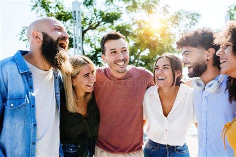 Group Of Smiling Young Friends Having Fun Together Outdoors Stock Photo