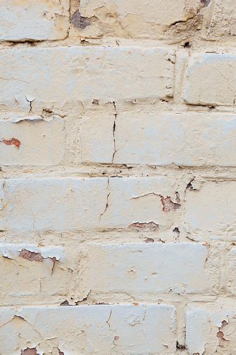 Poorly Painted Wall Of Damaged Red Brick With White Paint Stock Photo