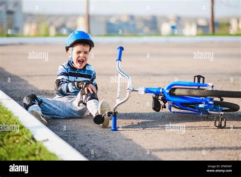 A Small Child Fell From A Bicycle Crying And Screaming In Pain Stock