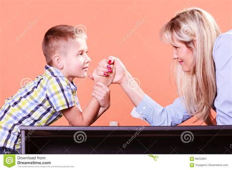 Mother And Son Arm Wrestle Sit At Table Stock Image Image Of