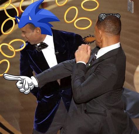 Two Men In Tuxedos Are Dancing On The Oscars Red Carpet With Blue Hair