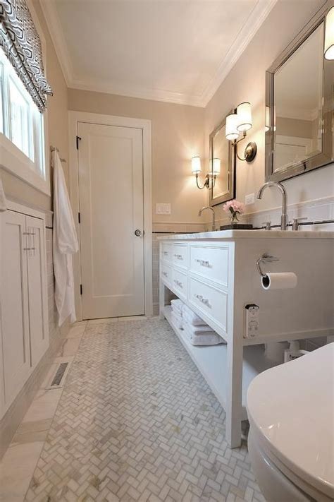 Elkins Sconces Illuminating A Narrow Bathroom Designed With A White