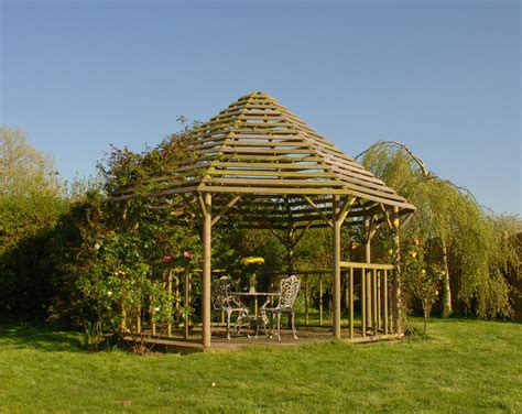 A Hexagonal Gazebo With A Horizontally Slatted Roof Perfect For