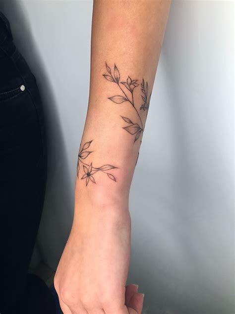 pin by anastasia on tattoo wrap around wrist tattoos flower wrist tattoos vine tattoos
