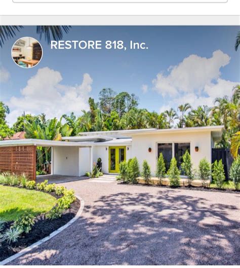 The exterior renovation of the home includes a pop of bright turquoise on the door and natural wood panels on the side of the carport. Carport and circular driveway! | Modern landscape design ...