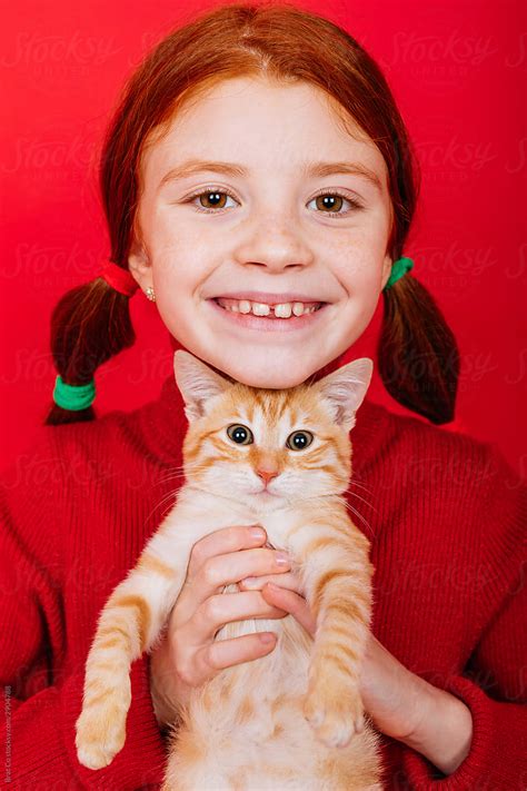 little redhead with cat by stocksy contributor brat co stocksy