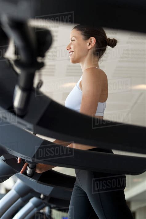 Woman On Exercise Machine At Gym Stock Photo Dissolve
