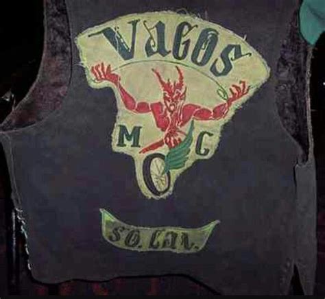 The Back Of A Black Vest With An Image Of A Man On It That Says Vilcos Mcg