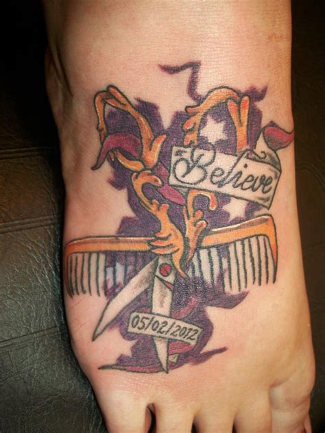 Scissor And Comb With Beauty Banner Tattoo On Back Shoulder