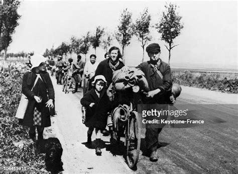 A Group Of Refugees Fleeing Upon The Arrival Of German Troops On The