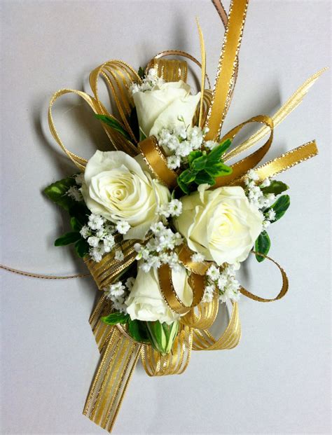 Gold Ribbons Accent A Mix Of Creamy White Spray Roses And Babies Breath