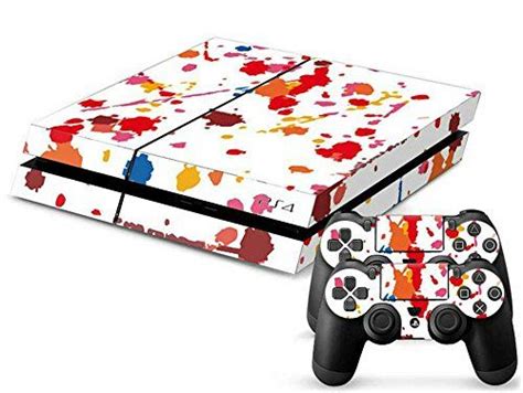 A Video Game Console And Controller With Colorful Paint Splattered On