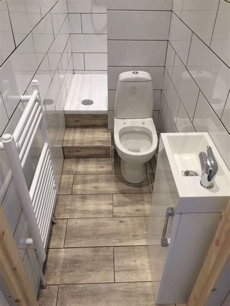 A Small Bathroom With A Toilet Sink And Radiator Next To Each Other