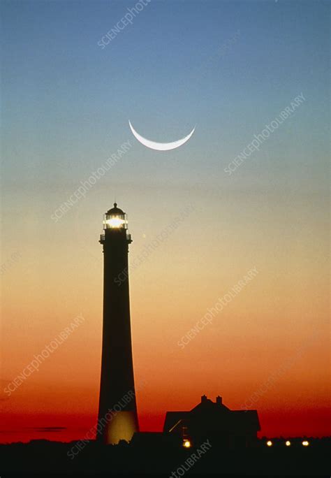 Crescent Moon Over Lighthouse At Sunrise Stock Image T6660025
