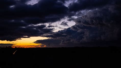 Download Wallpaper 2560x1440 Windmill Clouds Night Overcast Horizon