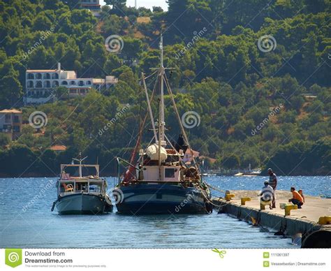 Skiathos Greece Fishermen On The Dock Near The Fishing Boats