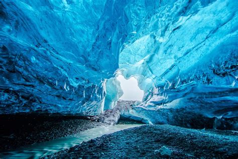 Blue Crystal Ice Cave Entrance And An Underground River Beneath The