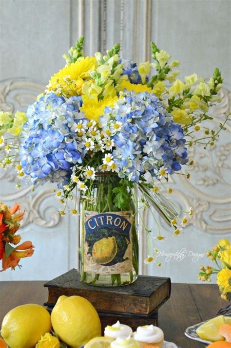 A Clear Jar With Bright Yellow And Blue Flowers Is A Bold And Cool
