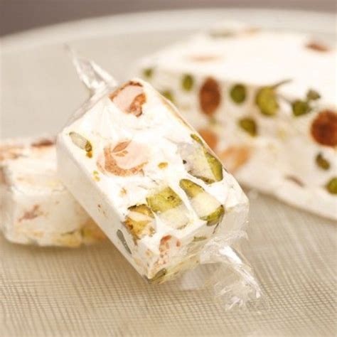 Brown sugar, white sugar, butter and vinegar go into these hard candies flavored with a hint of vanilla. Nougat Candy with Almonds and Pistachios | Nougat recipe ...
