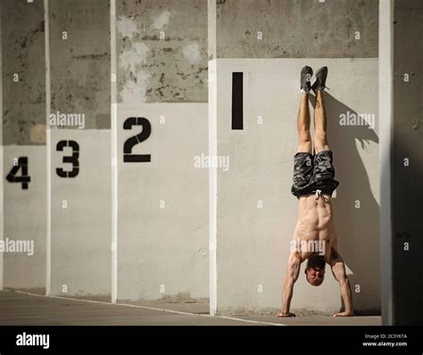 Man Doing Handstand Next To Wall Stock Photo Alamy