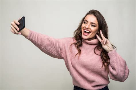 Portrait Of Smiling Cute Woman Making Selfie Photo On Smartphone
